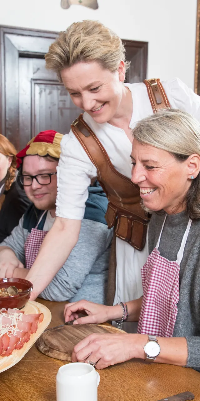 Group enjoying traditional food workshop in a rustic dining room setting